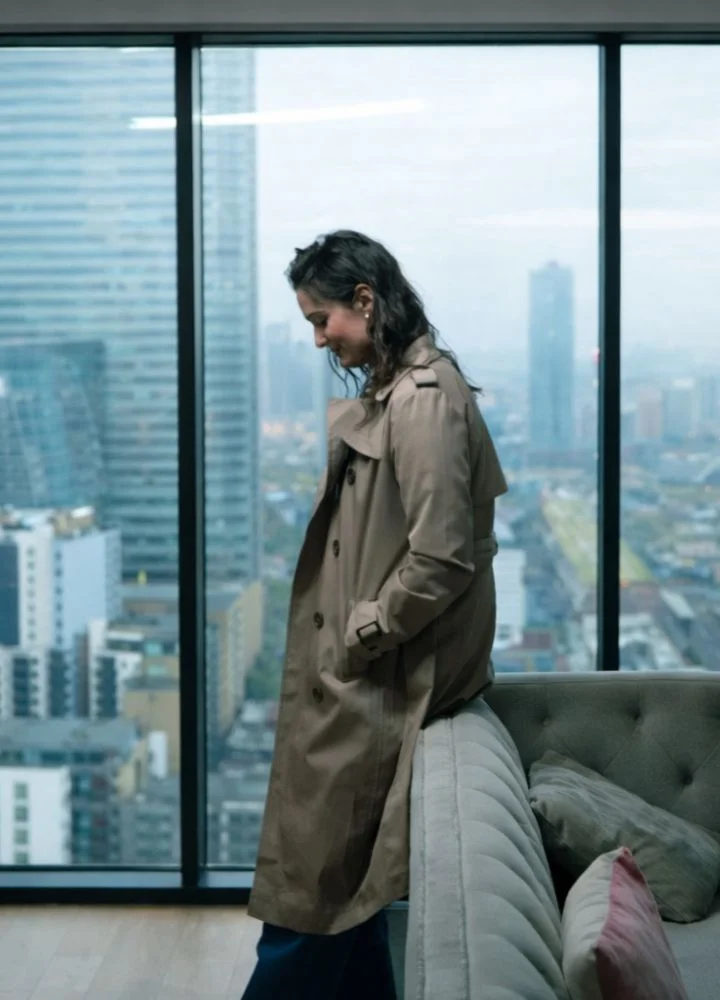 lauren-budd-jitters-2026-brown-trench-coat.webp
