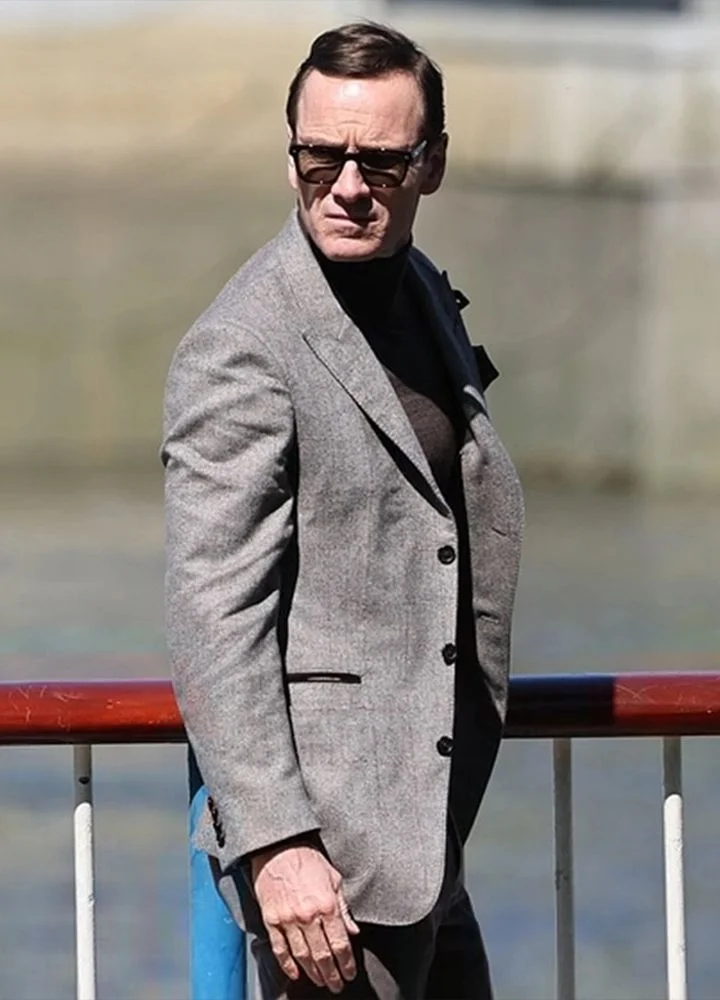 michael-fassbender-black-bag-grey-blazer.webp